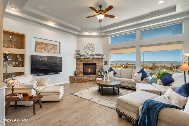 a bed sitting in a room next to a window and a chandelier