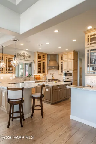 a kitchen with stainless steel appliances granite countertop a stove sink and cabinets