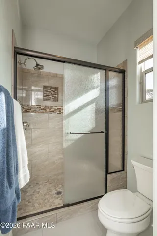 a view of a chairs and table in patio with a lake view