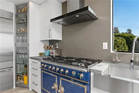 a kitchen with stainless steel appliances granite countertop a stove and a sink