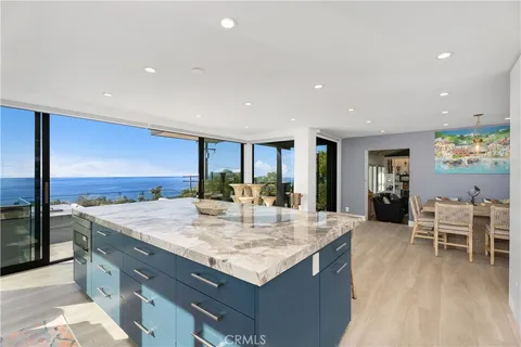 a kitchen with center island table and chairs
