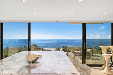 a kitchen with center island table and chairs