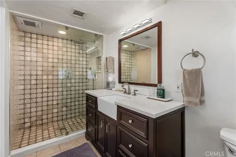 a bathroom with a sink vanity granite and a mirror