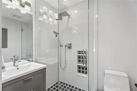 a bathroom with a shower sink and mirror
