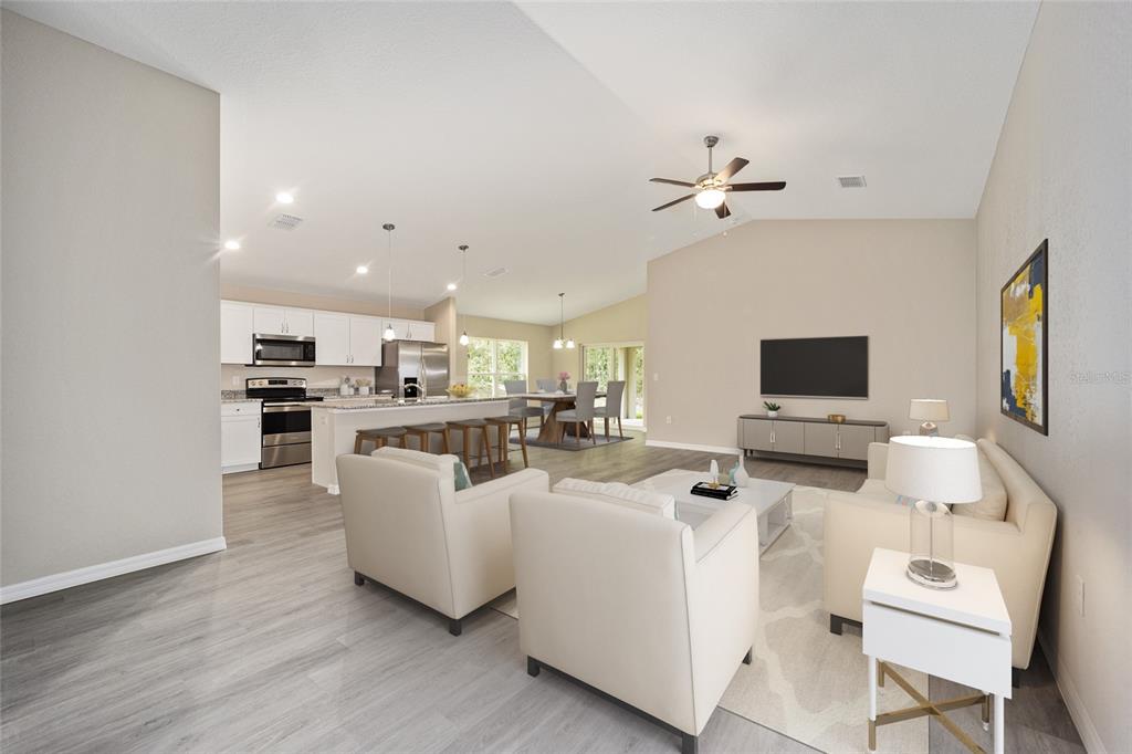 17600 Southwest 113th Place Dunnellon, FL 34432 - Photo 9 of 33 a living room with furniture a flat screen tv and kitchen view