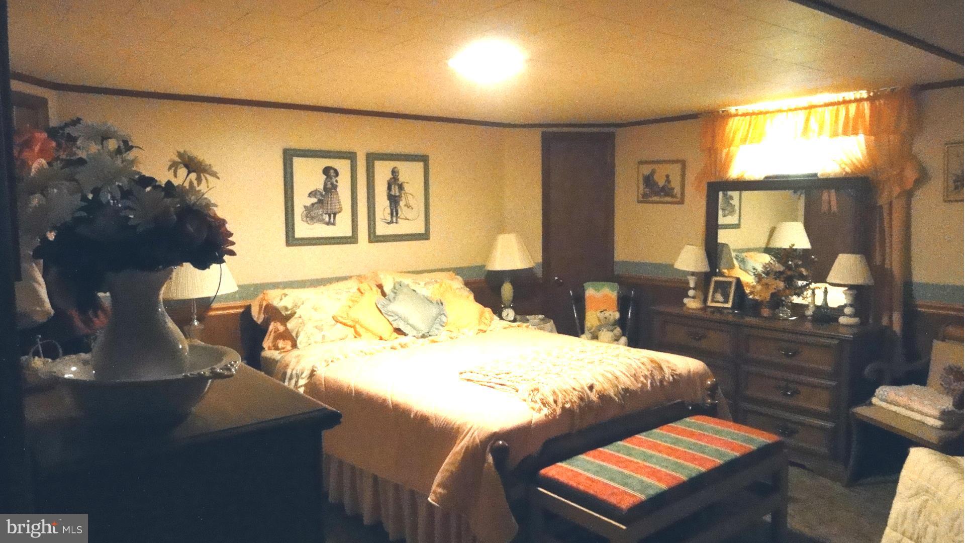3726 Collier Road Randallstown, MD 21133 - Photo 14 of 20 a bedroom with a bed and wooden floor