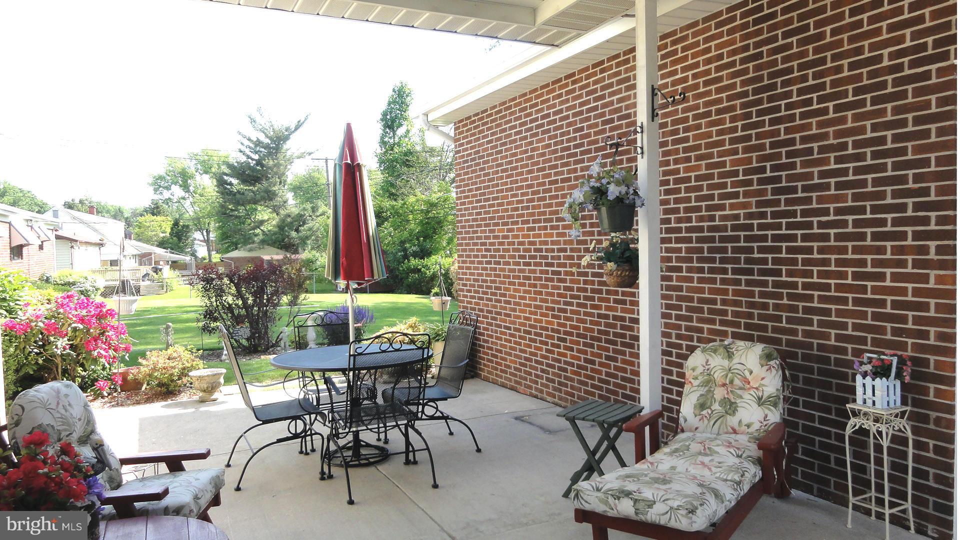 3726 Collier Road Randallstown, MD 21133 - Photo 17 of 20 a patio with table and chairs and potted plants