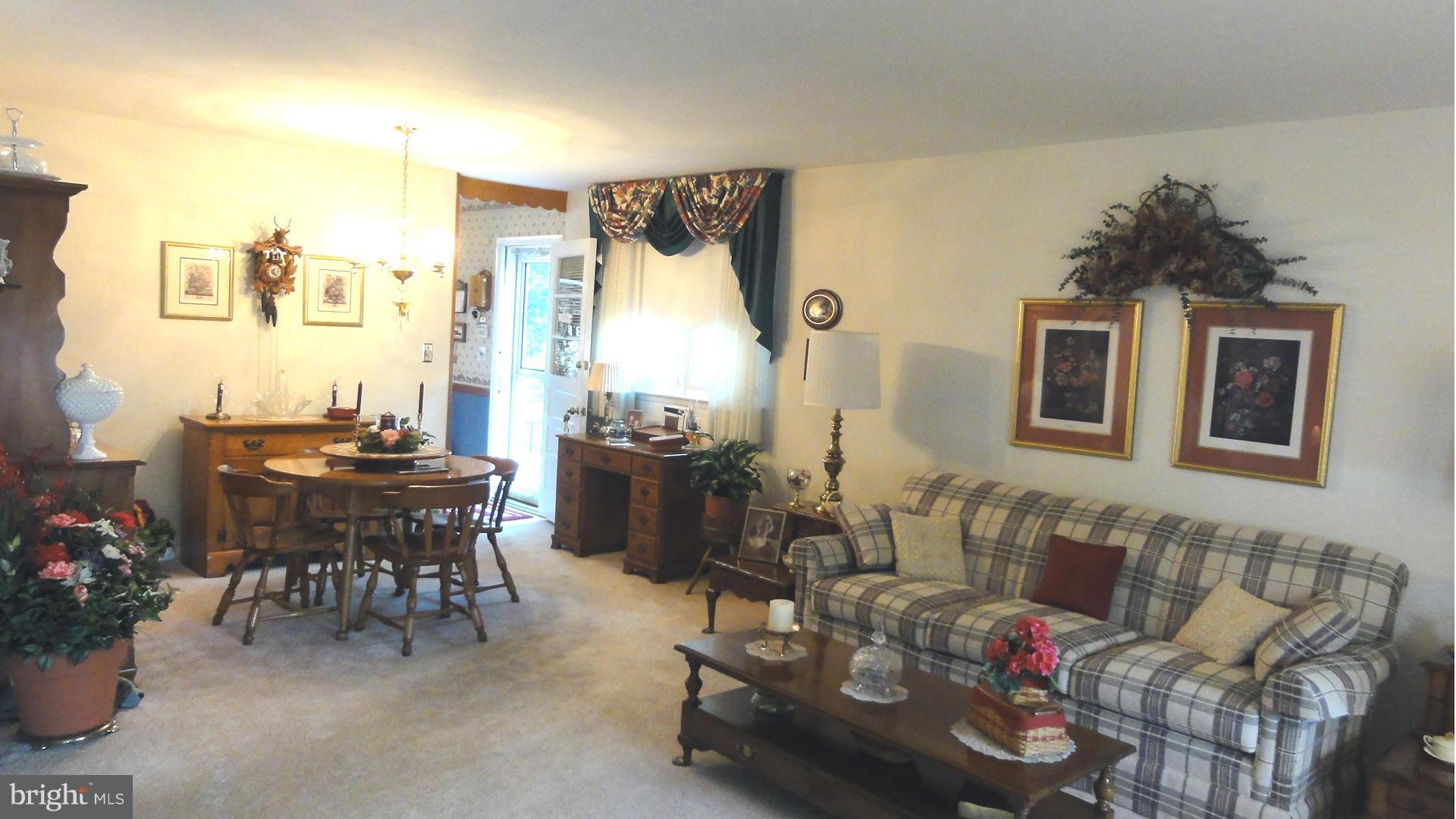 3726 Collier Road Randallstown, MD 21133 - Photo 3 of 20 a dining room with furniture and a potted plant