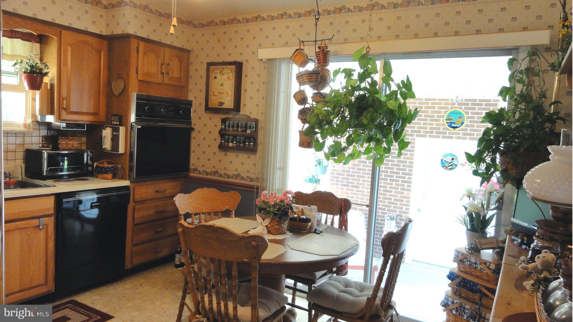 3726 Collier Road Randallstown, MD 21133 - Photo 5 of 20 a dining room with furniture a potted plant and a window