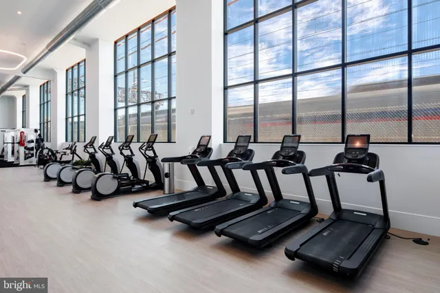 a view of gym with large windows