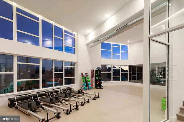 a view of a building with a large window and sitting area