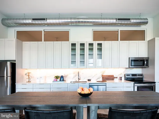 a kitchen with a sink a stove and cabinets