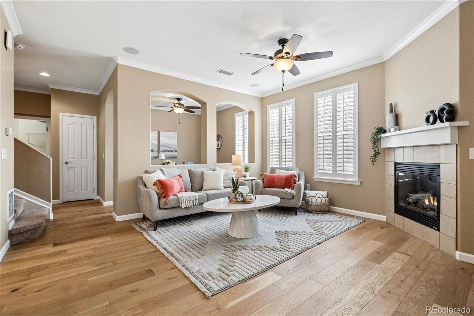 485 Elmhurst Way, Unit C Highlands Ranch, CO 80129 - Photo 12 of 42 a living room with furniture and a fireplace