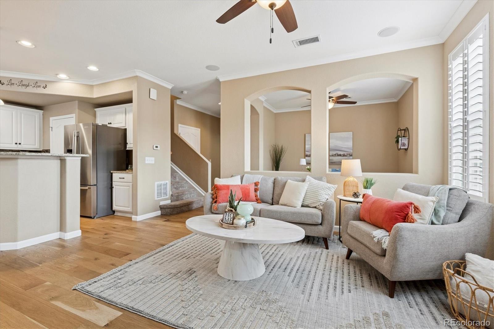 485 Elmhurst Way, Unit C Highlands Ranch, CO 80129 - Photo 13 of 42 a living room with furniture and a chandelier