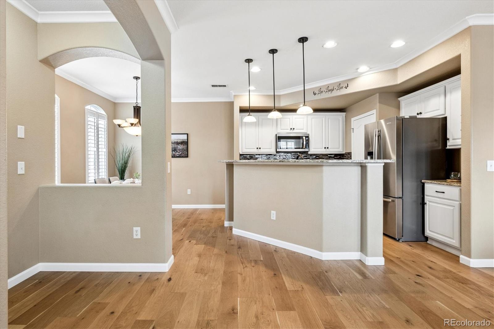 485 Elmhurst Way, Unit C Highlands Ranch, CO 80129 - Photo 14 of 42 a kitchen with stainless steel appliances granite countertop a refrigerator a sink and a stove