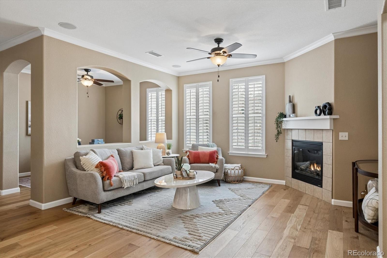 485 Elmhurst Way, Unit C Highlands Ranch, CO 80129 - Photo 20 of 42 a living room with furniture and a fireplace