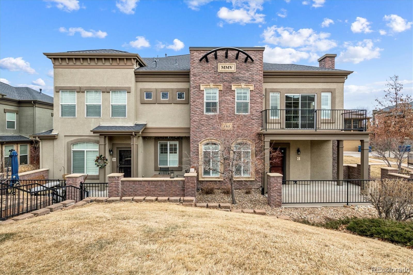 485 Elmhurst Way, Unit C Highlands Ranch, CO 80129 - Photo 2 of 42 a front view of a building with a glass door