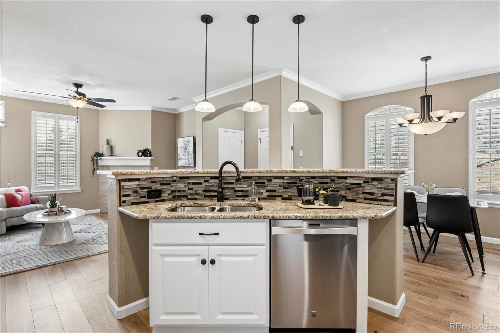 485 Elmhurst Way, Unit C Highlands Ranch, CO 80129 - Photo 22 of 42 a kitchen with a stove and a wooden floor