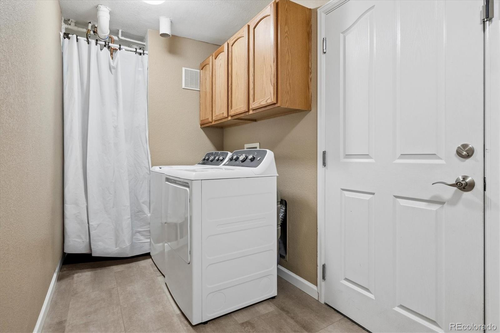 485 Elmhurst Way, Unit C Highlands Ranch, CO 80129 - Photo 27 of 42 a utility room with dryer and washer