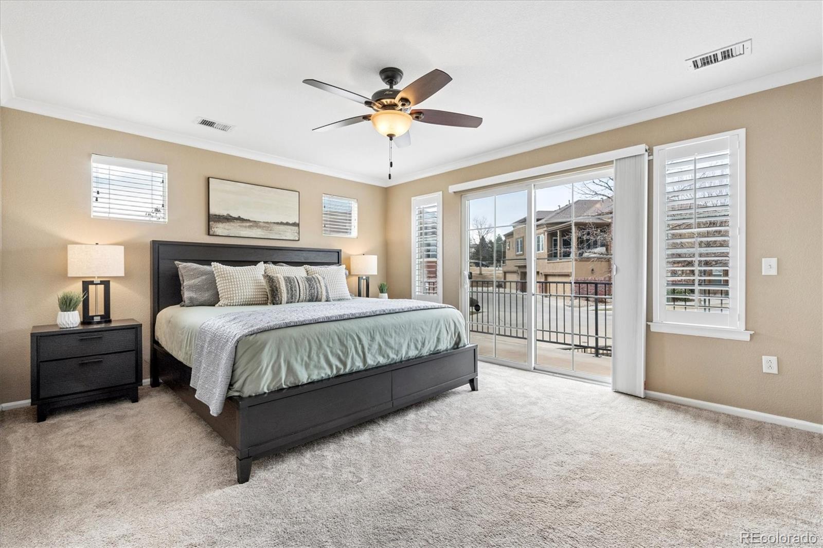 485 Elmhurst Way, Unit C Highlands Ranch, CO 80129 - Photo 30 of 42 a spacious bedroom with a bed and a large window