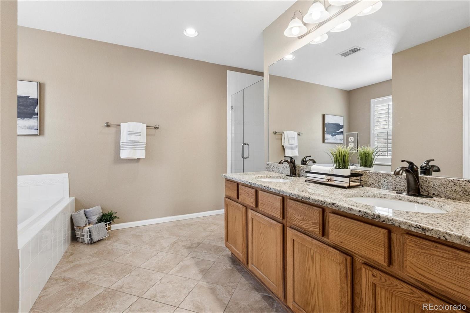 485 Elmhurst Way, Unit C Highlands Ranch, CO 80129 - Photo 32 of 42 a bathroom with a sink double vanity and a mirror