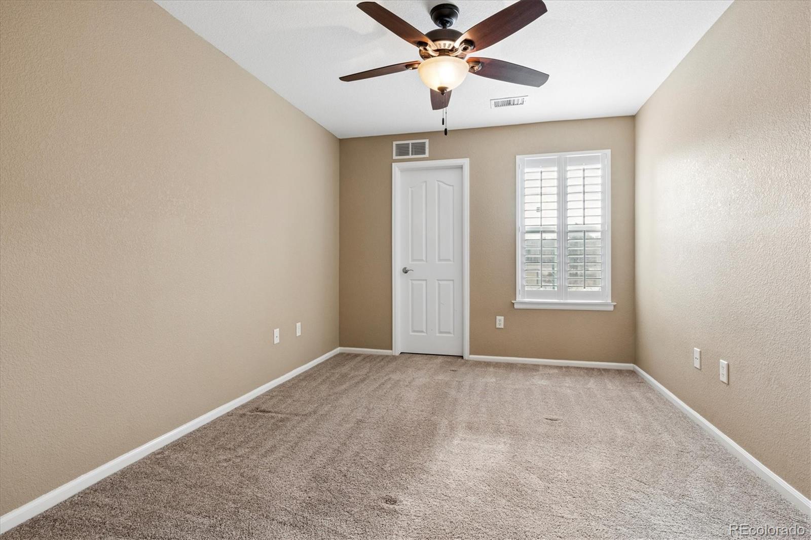 485 Elmhurst Way, Unit C Highlands Ranch, CO 80129 - Photo 35 of 42 an empty room with windows and fan