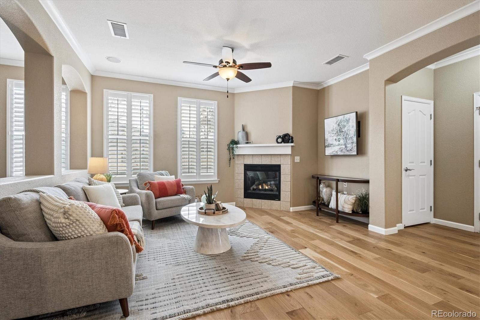 485 Elmhurst Way, Unit C Highlands Ranch, CO 80129 - Photo 7 of 42 a living room with furniture and a fireplace