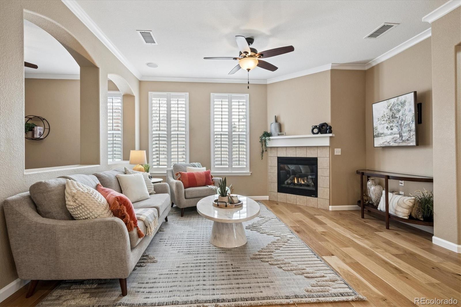 485 Elmhurst Way, Unit C Highlands Ranch, CO 80129 - Photo 8 of 42 a living room with furniture and a fireplace