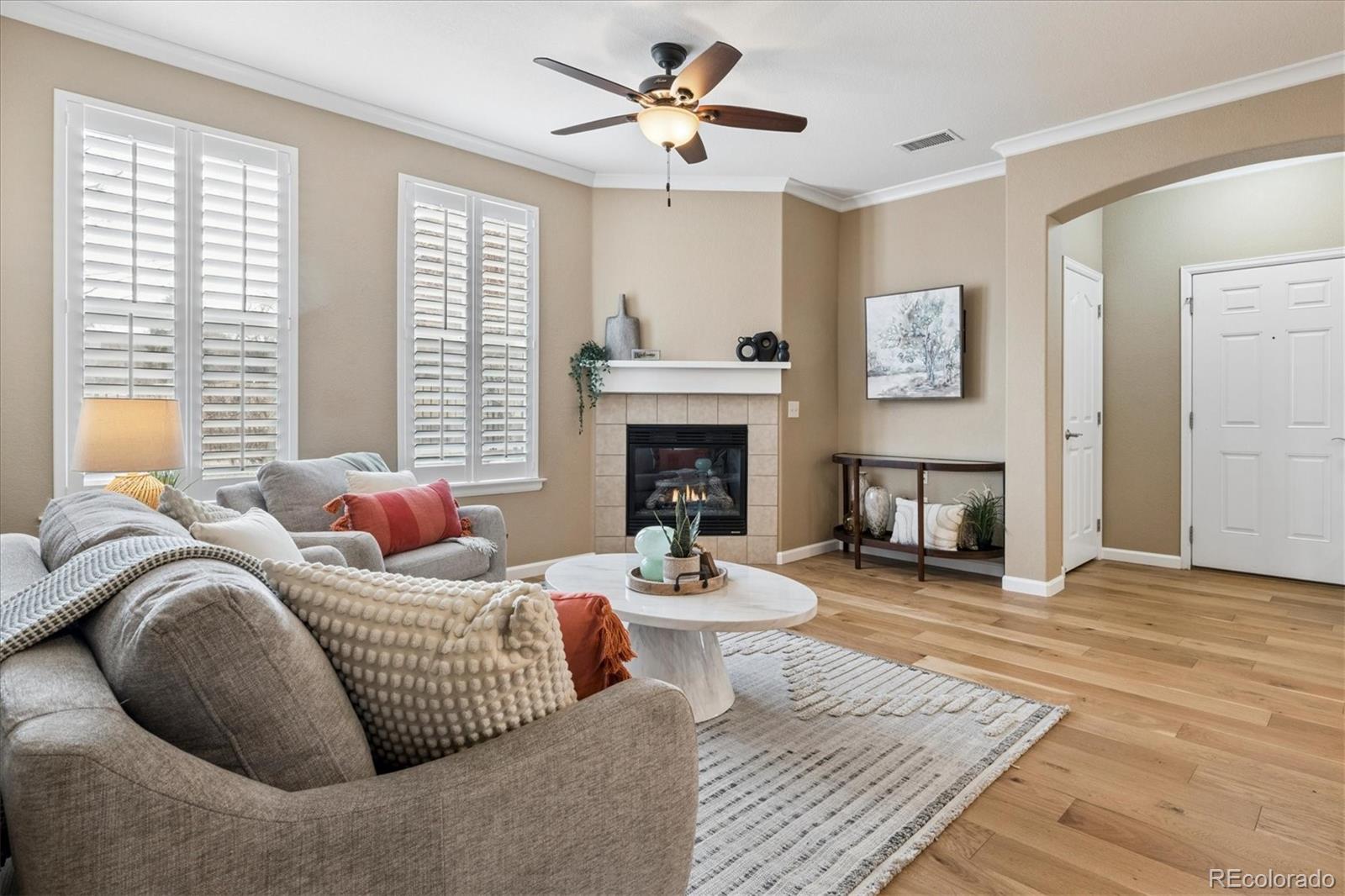 485 Elmhurst Way, Unit C Highlands Ranch, CO 80129 - Photo 9 of 42 a living room with furniture fireplace and window