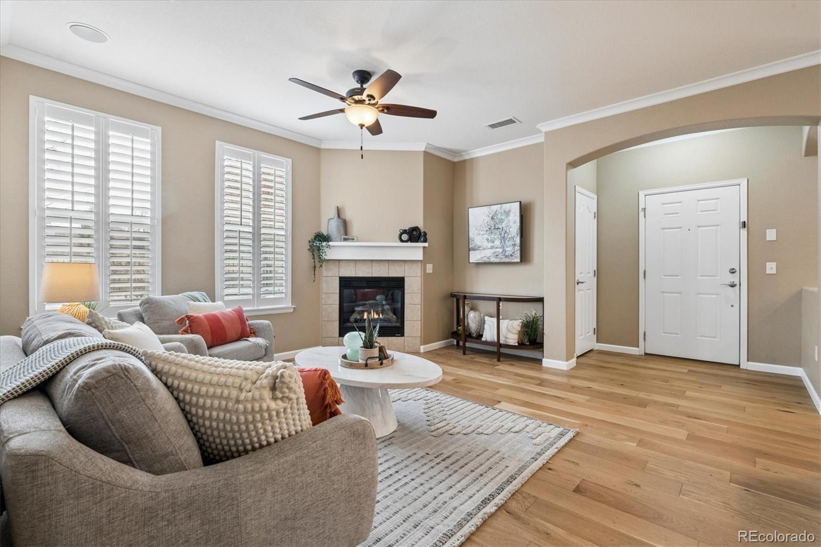 485 Elmhurst Way, Unit C Highlands Ranch, CO 80129 - Photo 10 of 42 a living room with furniture fireplace and a large window