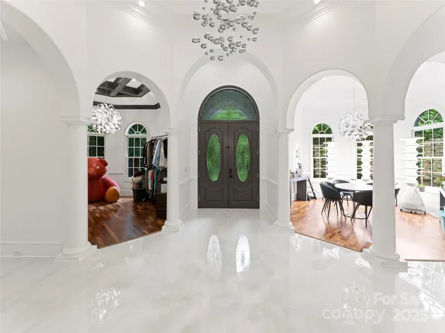 a view of a living room and entryway with furniture