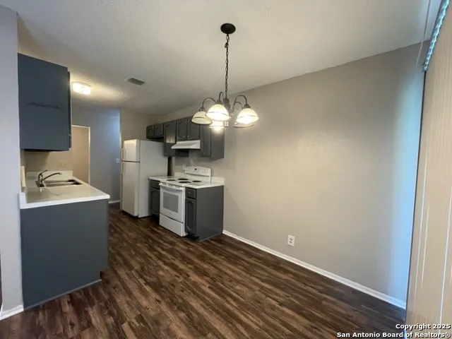 a kitchen with stainless steel appliances granite countertop a sink a refrigerator and a stove