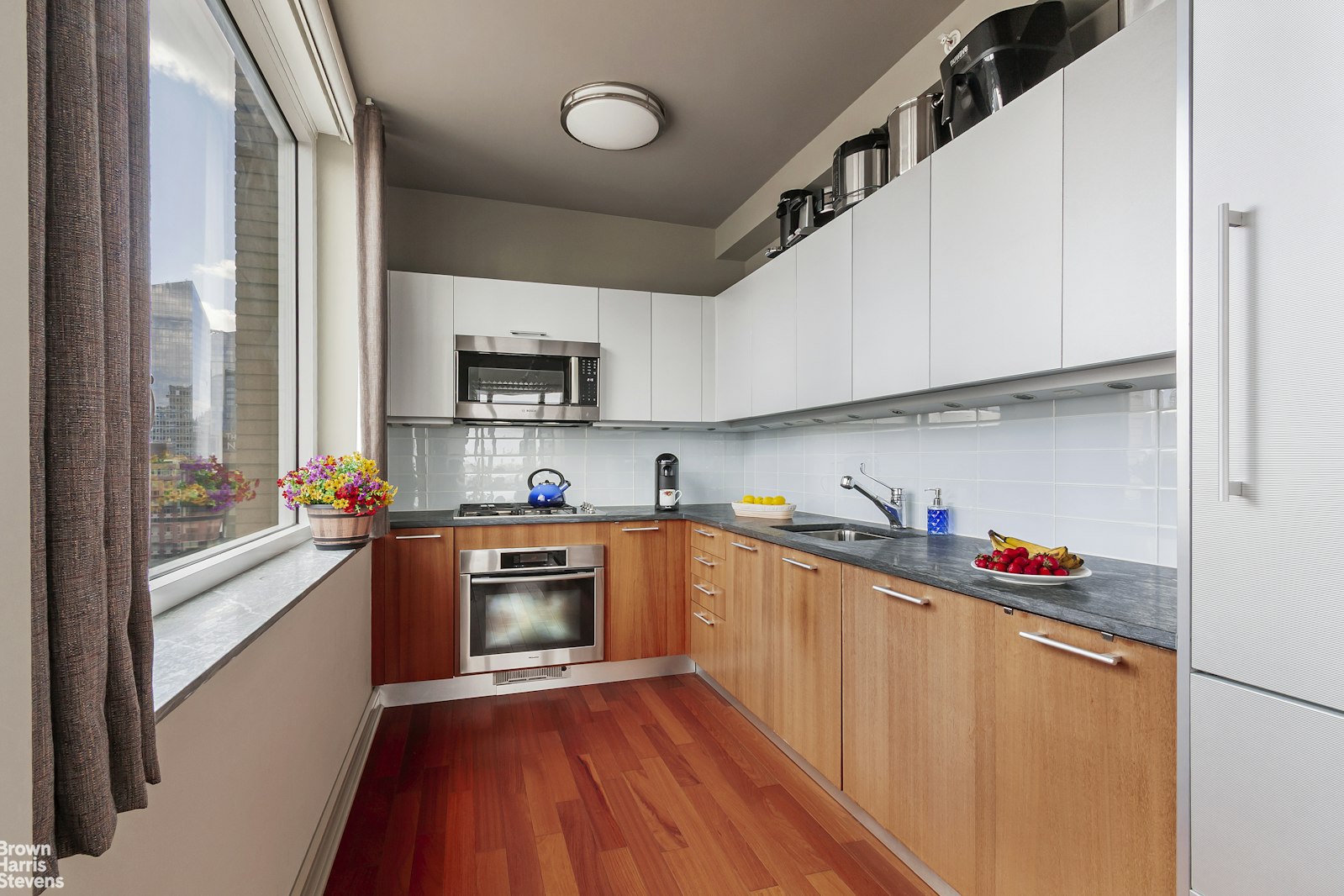 100 Riverside Boulevard, Unit 27A Manhattan, NY 10069 - Photo 26 of 48 a kitchen with stainless steel appliances granite countertop a sink and a refrigerator