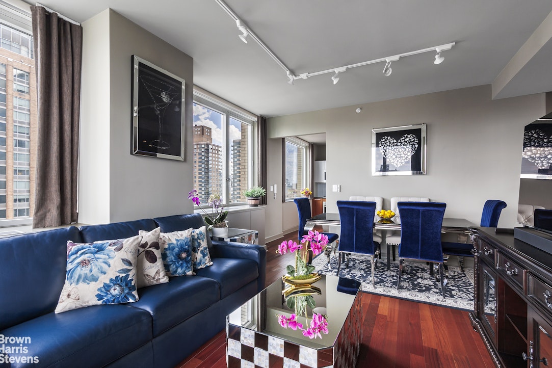 100 Riverside Boulevard, Unit 27A Manhattan, NY 10069 - Photo 2 of 48 a living room with furniture and wooden floor