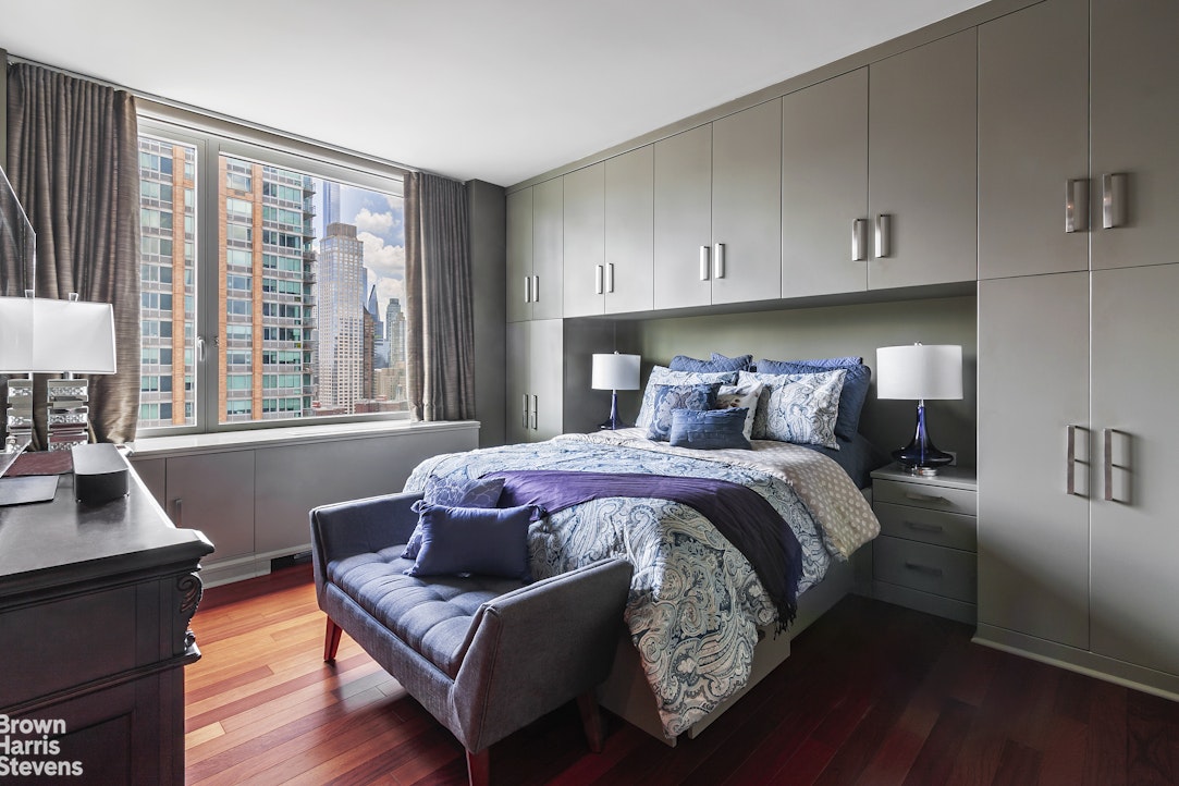 100 Riverside Boulevard, Unit 27A Manhattan, NY 10069 - Photo 4 of 48 a bedroom with a bed and wooden floor