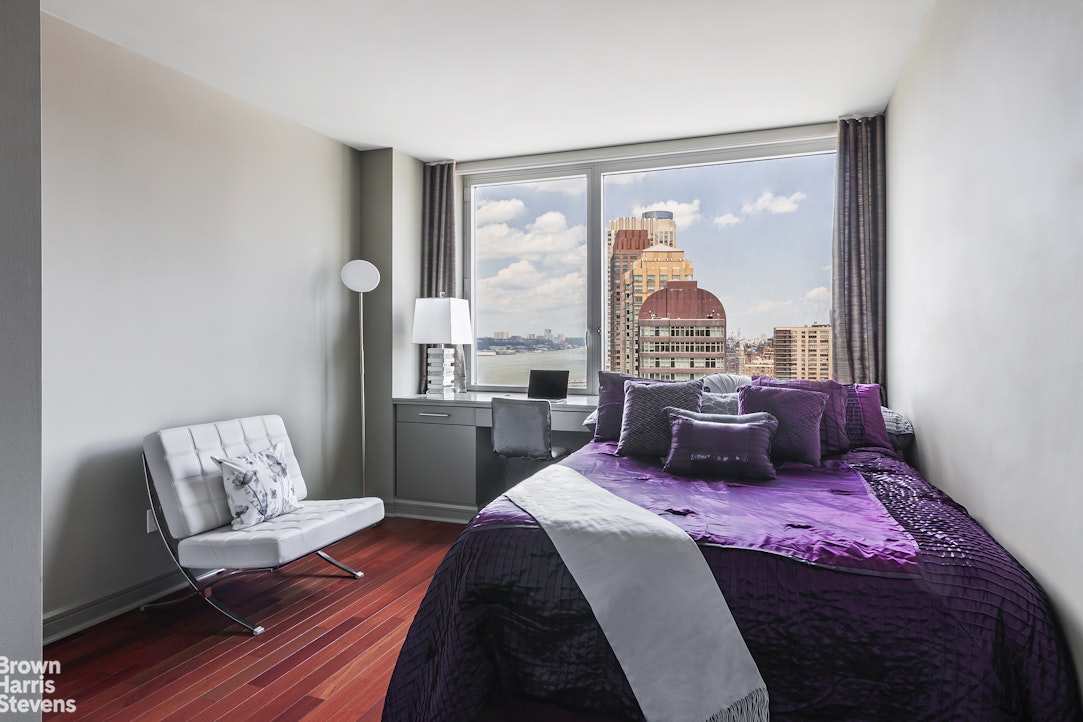 100 Riverside Boulevard, Unit 27A Manhattan, NY 10069 - Photo 5 of 48 a bed sitting in a bedroom next to a window