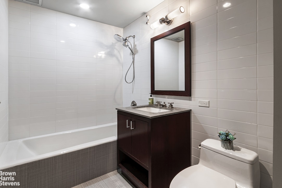 100 Riverside Boulevard, Unit 27A Manhattan, NY 10069 - Photo 8 of 48 a bathroom with a sink toilet and shower