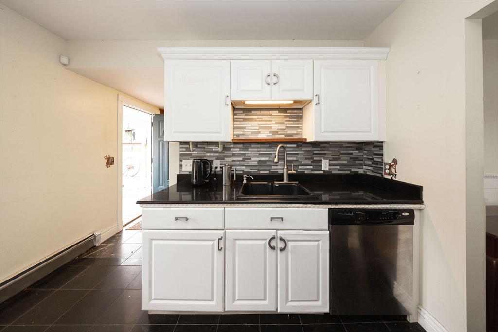 129 School Street Warren, MA 01083 - Photo 28 of 41 a view of kitchen with granite countertop white cabinets and black appliances
