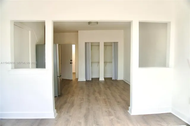 a view of a room with wooden floor