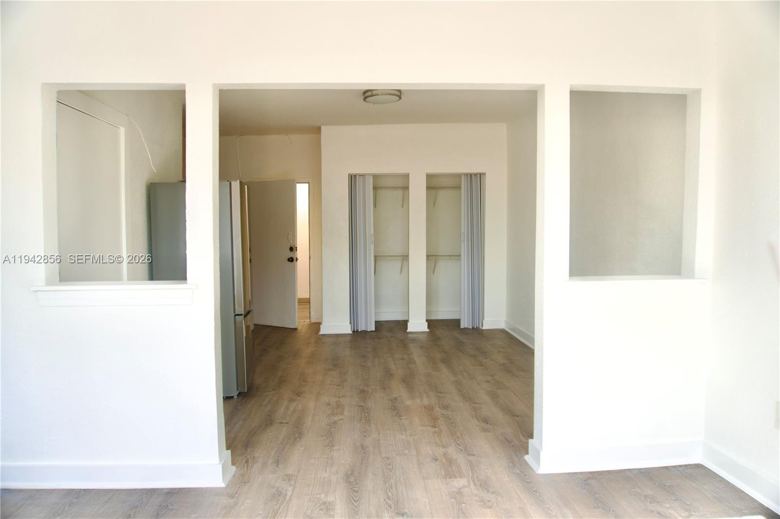 a view of a room with wooden floor