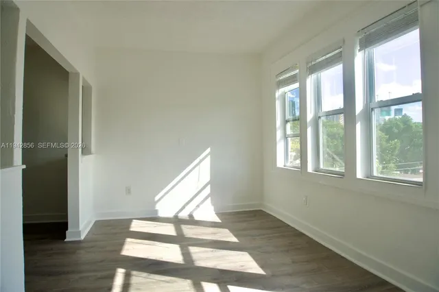 a view of an empty room and wooden floor