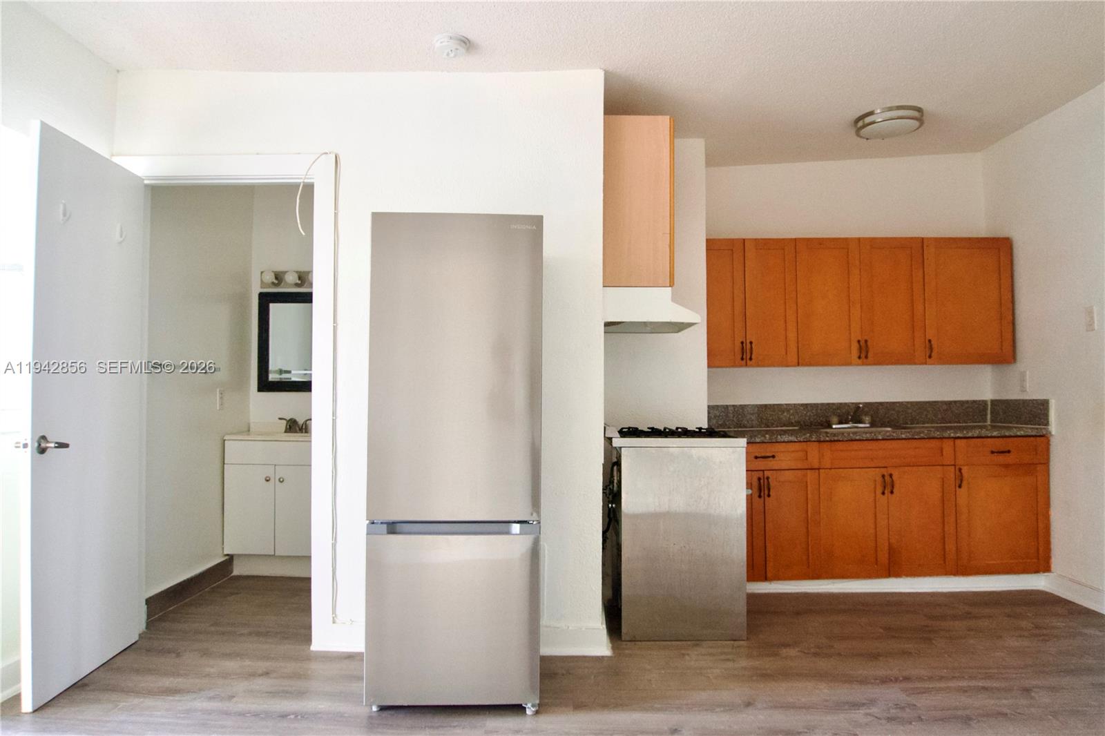 501 Southwest 6th Court, Unit 327 Miami, FL 33130 - Photo 8 of 20 a kitchen with stainless steel appliances granite countertop a refrigerator and a stove top oven