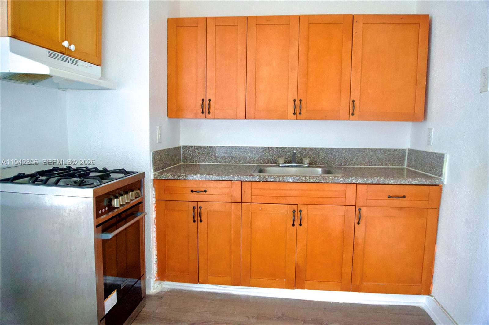 501 Southwest 6th Court, Unit 327 Miami, FL 33130 - Photo 9 of 20 a kitchen with a sink and cabinets