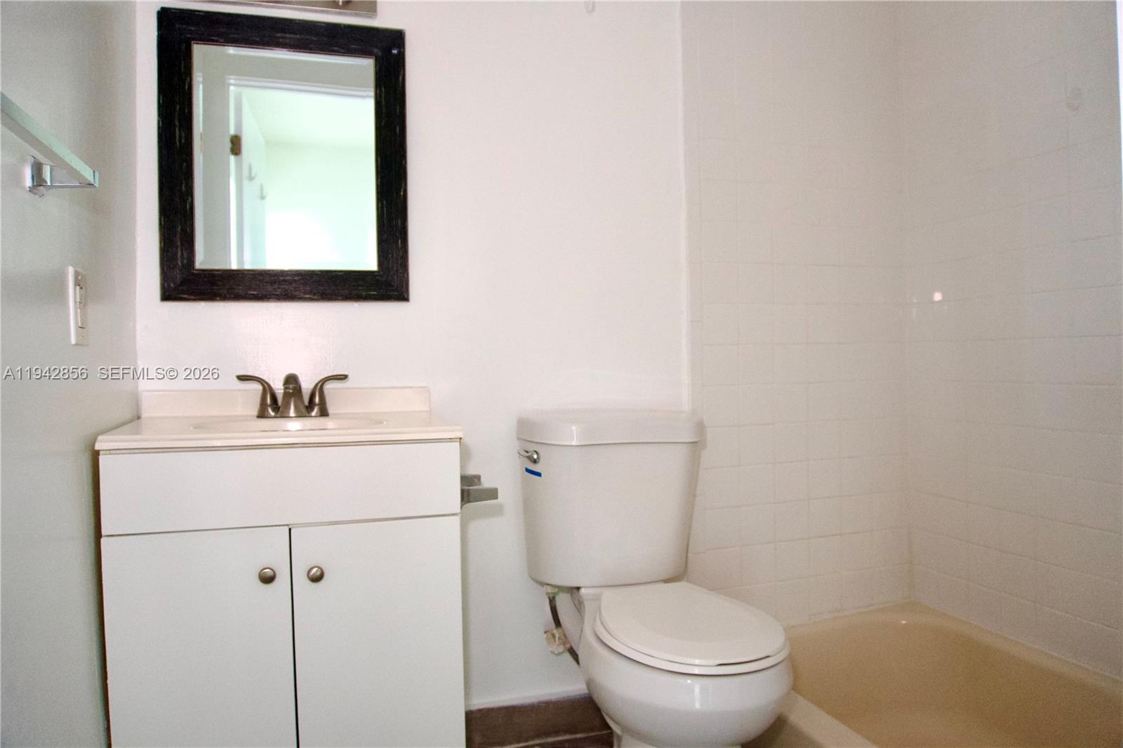 501 Southwest 6th Court, Unit 327 Miami, FL 33130 - Photo 10 of 20 a bathroom with a toilet sink and mirror