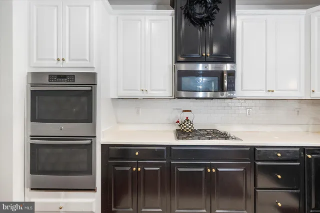 a kitchen with a refrigerator and cabinets