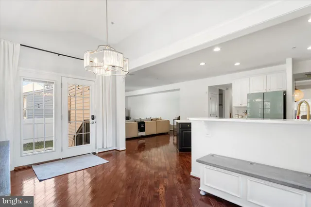 a view of a living room and kitchen with a large window