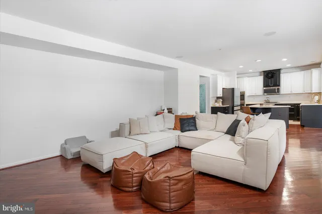 a living room with furniture and a wooden floor