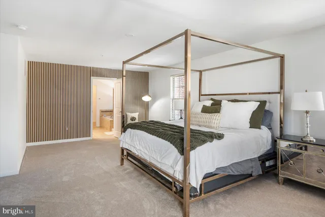 a bed room with a bed and a night stand