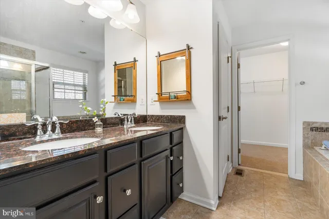 a bathroom with a granite countertop sink mirror and double