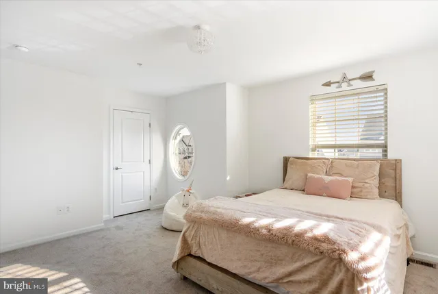 a bedroom with a bed and a window